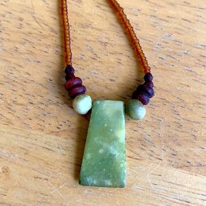 Green shell necklace with wooden bead accents